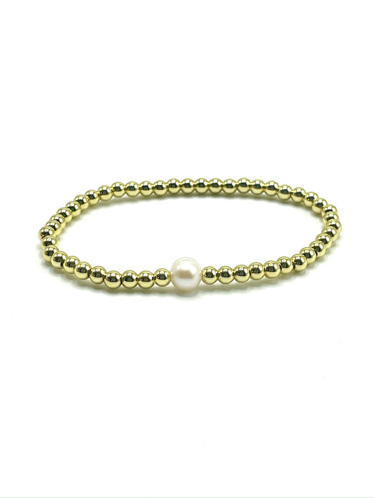 Gold stretchy bracelet with a single white freshwater pearl