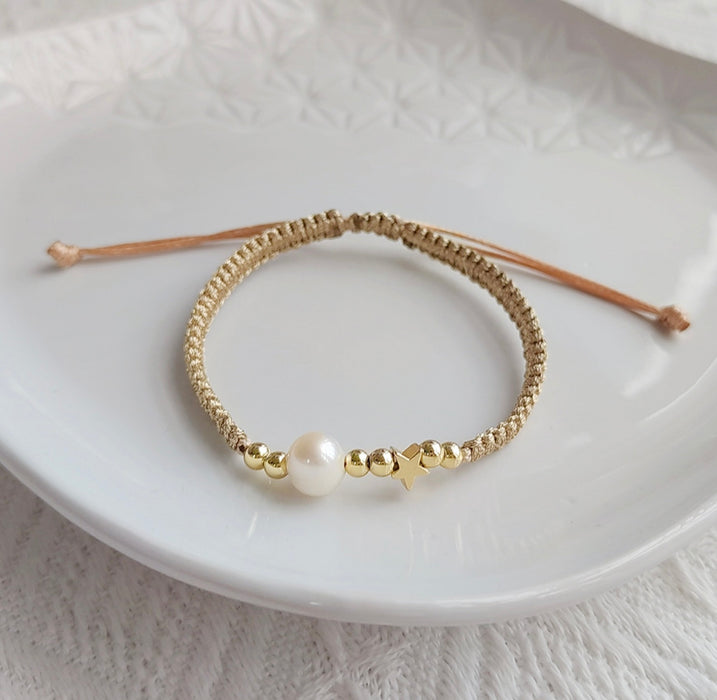 Gold braided bracelet with single white freshwater pearl
