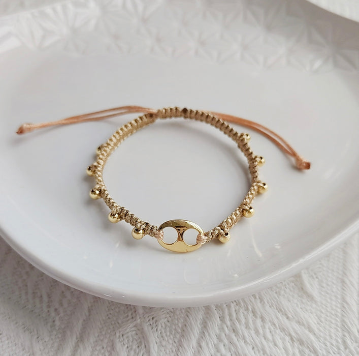 Gold braided bracelet with pig nose